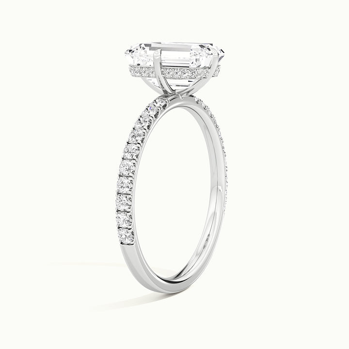 White gold emerald-cut compass pave hidden halo engagement ring, raised three-quarter view of the setting