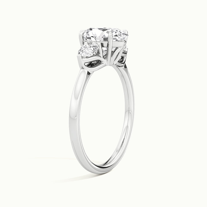 White gold oval-cut three-stone lotus floral engagement ring, raised three-quarter view of the setting