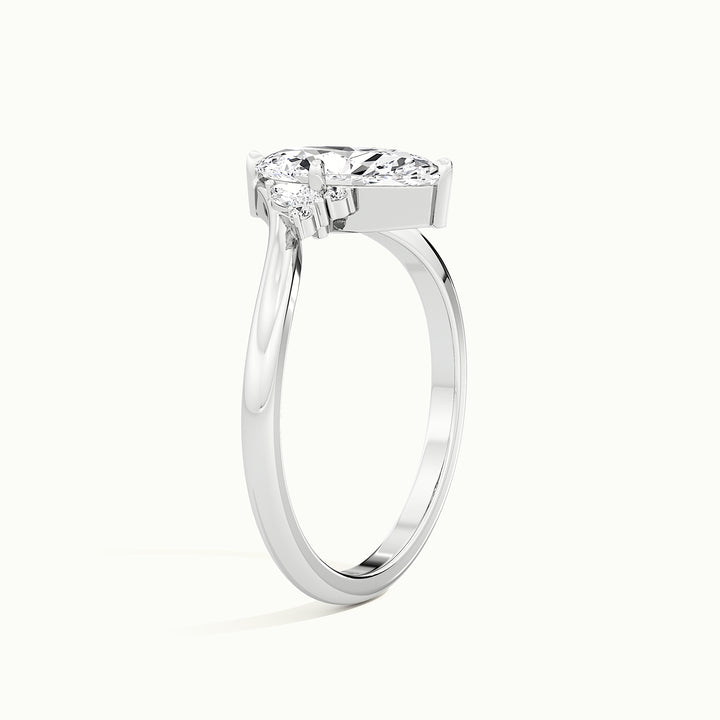 White gold marquise-cut V band with side-stone cluster engagement ring, raised three-quarter view of the setting