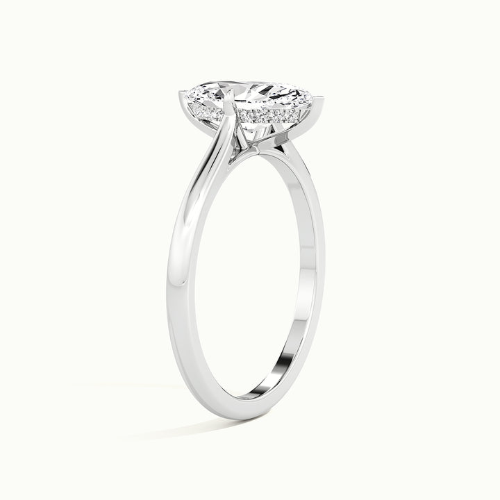 White gold marquise-cut hidden halo tapered shank engagement ring, raised three-quarter view of the setting